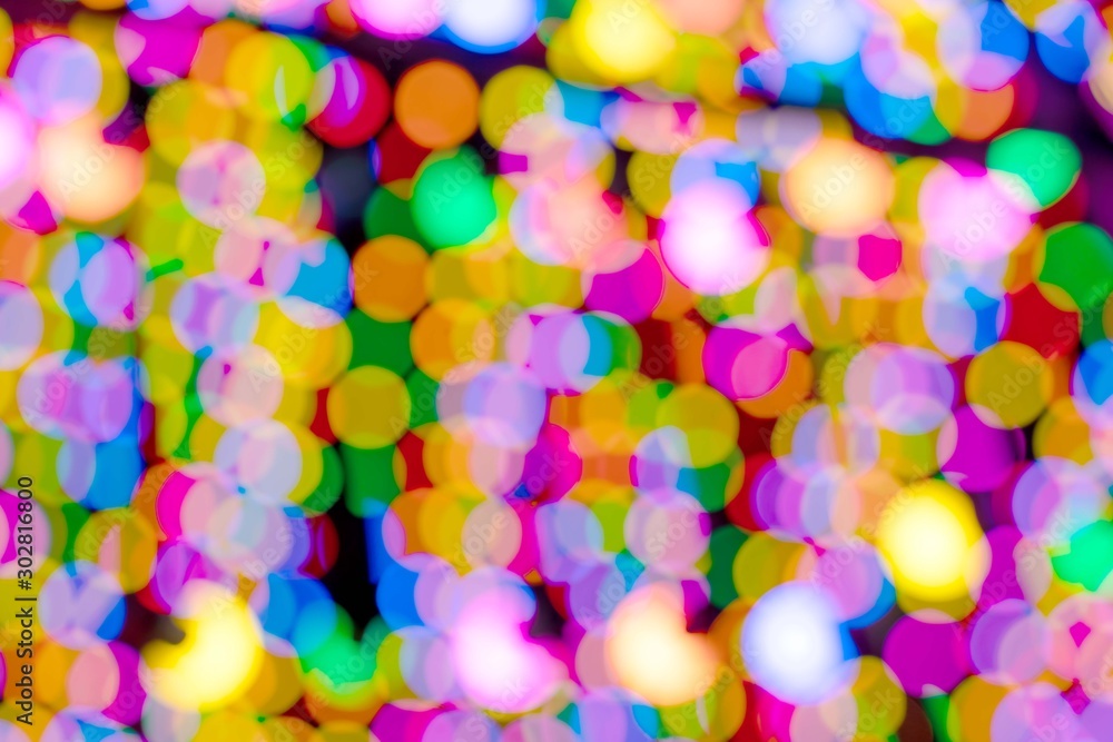 Colorful pink orange red bokeh background of Christmas lights and New year