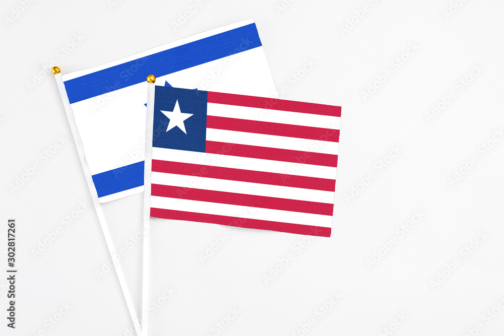 Liberia and Israel stick flags on white background. High quality fabric, miniature national flag. Peaceful global concept.White floor for copy space. Liberia and Israel stick flags on white background. High quality fabric, miniature national flag. Peaceful global concept.White floor for copy space.
