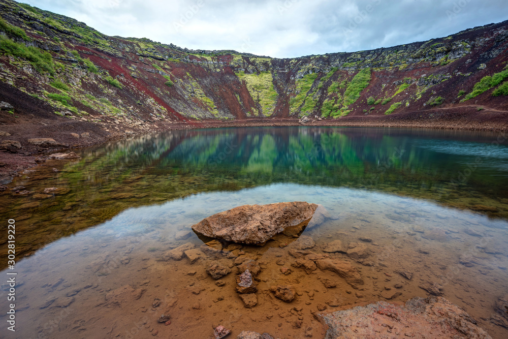 Plakat Kerid Crater lake on the Golden Circle in Iceland. A picturesque saphire blue lake surrounded by red walls inside the crater of a volcano