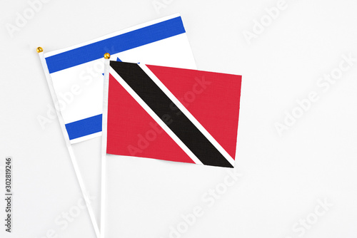Free Download Trinidad And Tobago and Israel stick flags on white background. High quality fabric, miniature national flag. Peaceful global concept.White floor for copy space. - GFXLoad