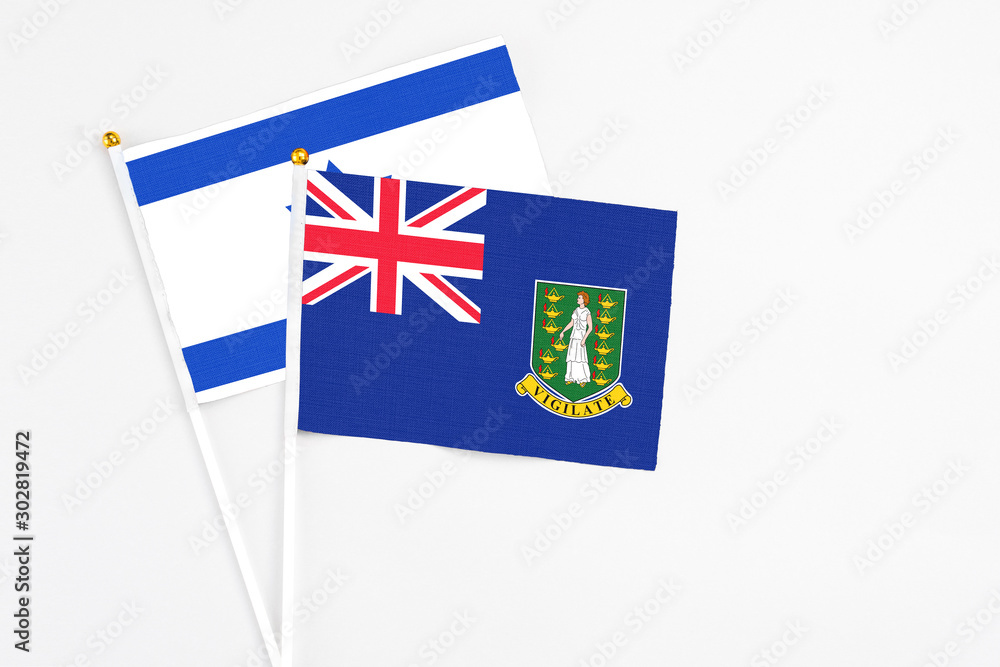 Fototapeta premium British Virgin Islands and Israel stick flags on white background. High quality fabric, miniature national flag. Peaceful global concept.White floor for copy space.