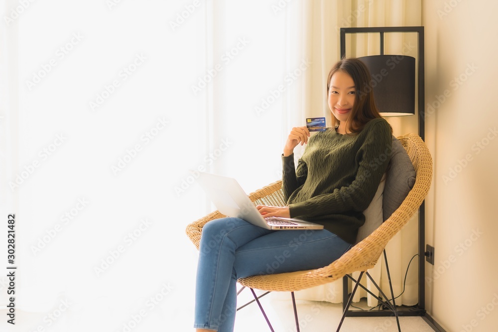 Portrait beautiful young asian women using computer laptop or smart and mobile phone with credit card for online shopping Portrait beautiful young asian women using computer laptop or smart and mobile phone with credit card for online shopping