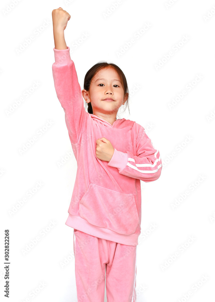 Cheerful little Asian child girl in pink tracksuit or sport cloth with raising hands up isolated on white background. Winner sport and success concept. Cheerful little Asian child girl in pink tracksuit or sport cloth with raising hands up isolated on white background. Winner sport and success concept.