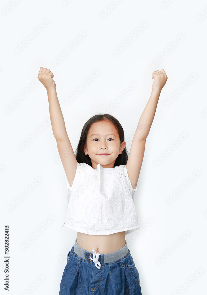 Cheerful happy little Asian child girl raising hands up isolated on white background. Success and confident concept. Cheerful happy little Asian child girl raising hands up isolated on white background. Success and confident concept.
