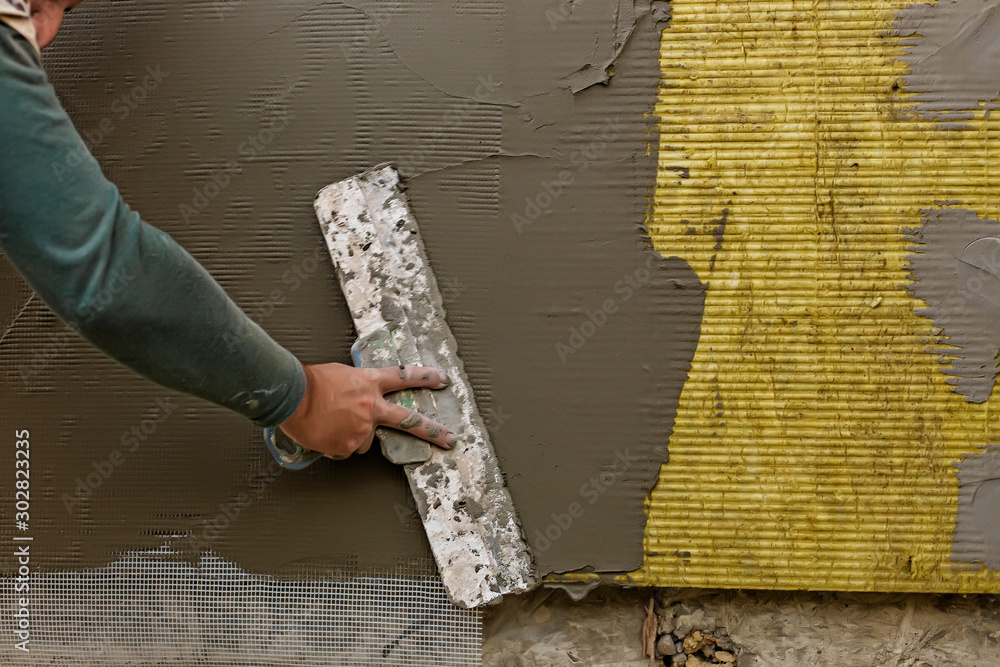 Plastrerer man plastering mineral wool slabs (rock wool, mineral cotton