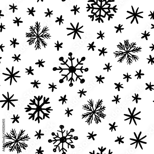 Seamless vector background with randomly arranged snowflakes. Sketch illustration