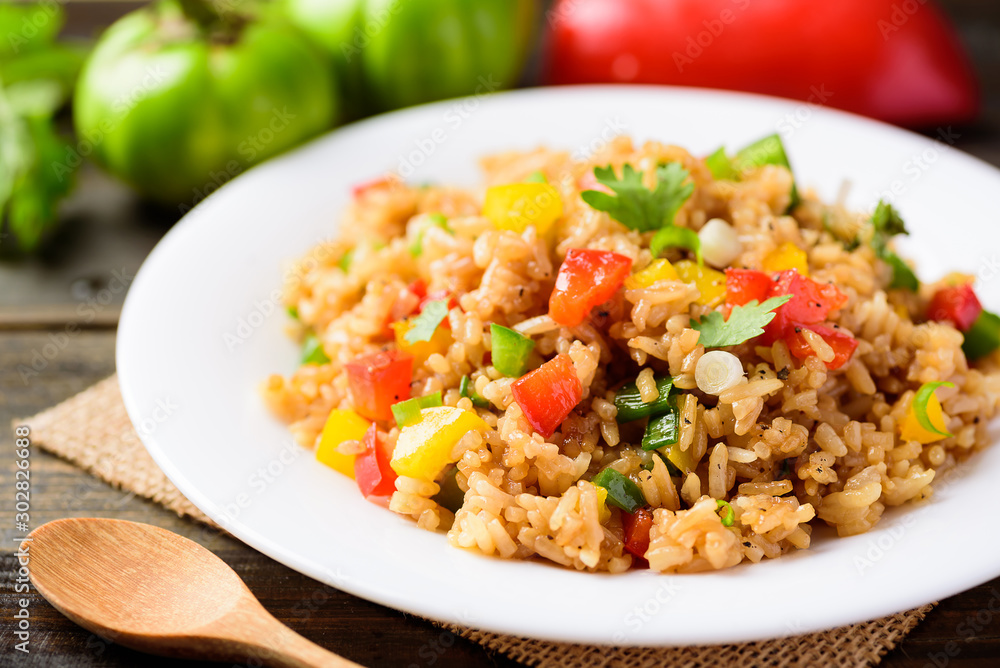 Fried rice with vegetables on white dish, Asian food Fried rice with vegetables on white dish, Asian food