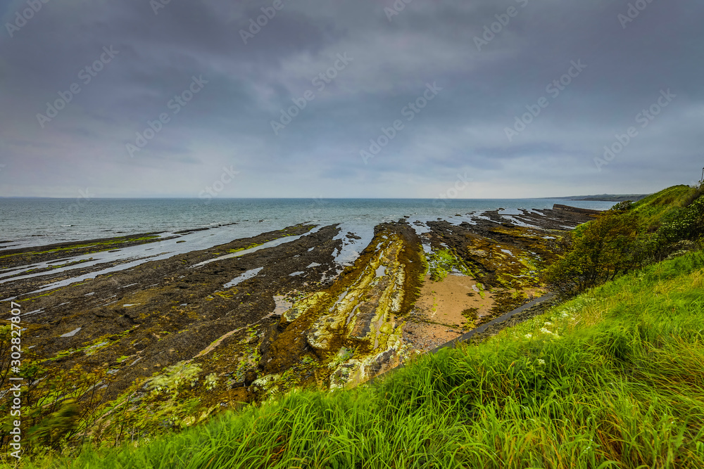 Waves breaking on coastal cliffs of Scotland.