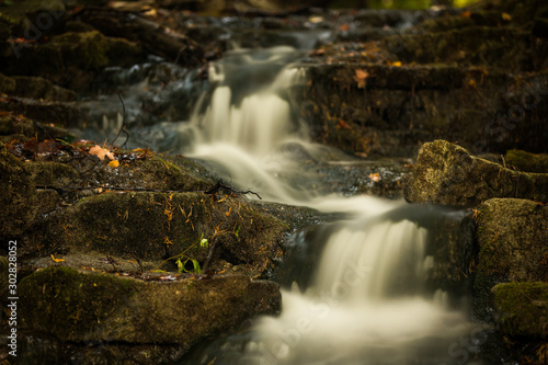 Fototapeta Naklejka Na Ścianę i Meble -  Small Cascading Waterfall in the Forest