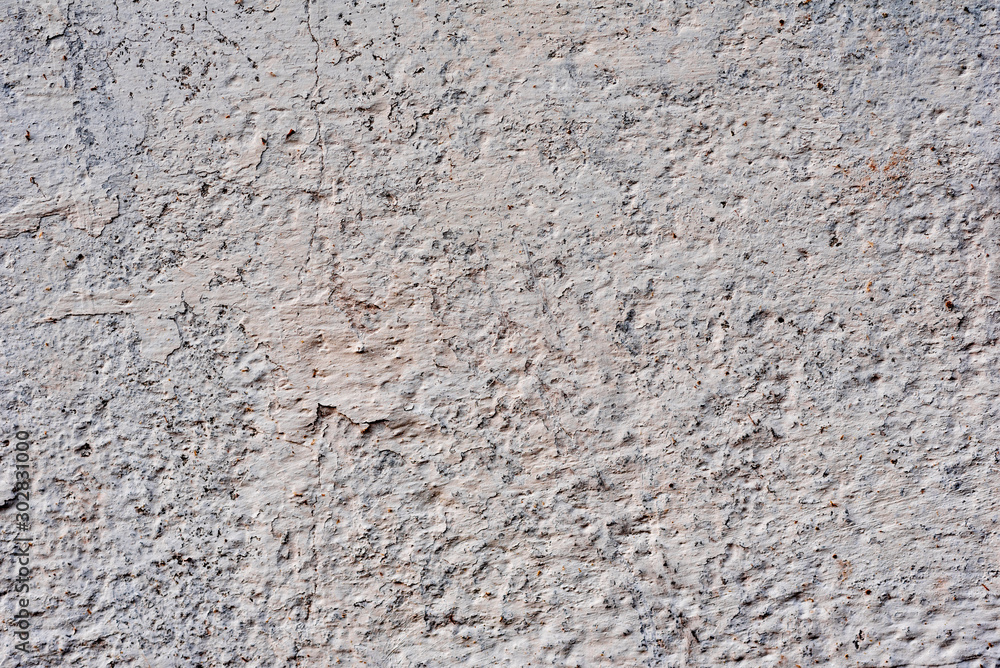 Texture of a concrete wall with cracks and scratches which can be used as a background Texture of a concrete wall with cracks and scratches which can be used as a background