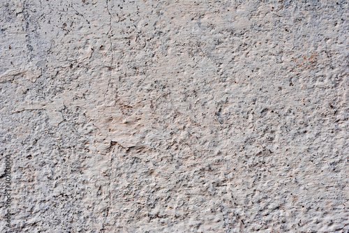 Texture of a concrete wall with cracks and scratches which can be used as a background