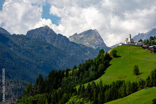 View of a mountain settlement in Italy. Mountain valley of the Alps, Dolomites. Summer sunny day