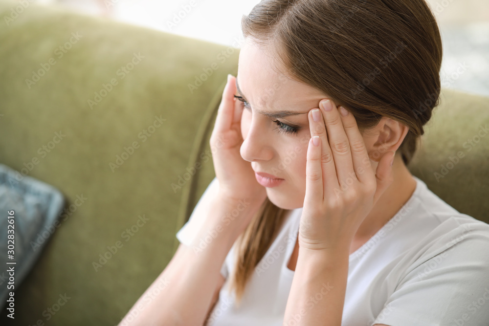 Young woman suffering from headache at home Young woman suffering from headache at home