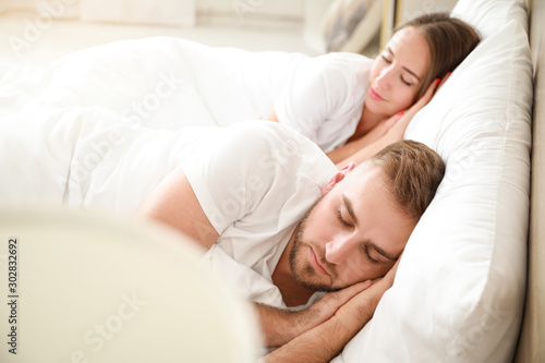 Morning of young couple sleeping in bed