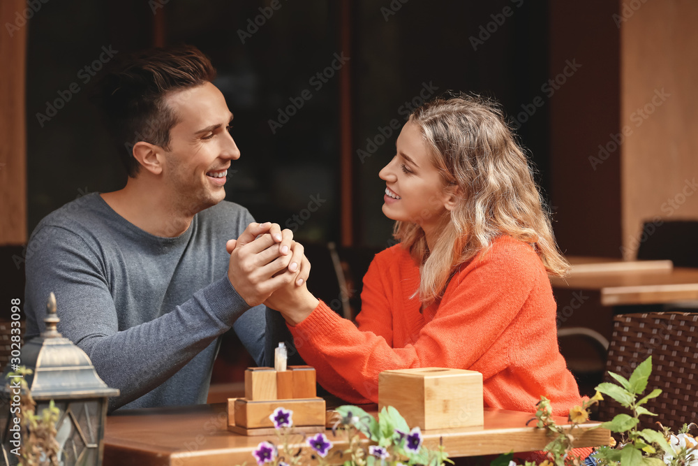 Fototapeta premium Happy young couple on romantic date in cafe