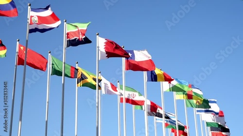 Flags of many states are fluttering on flagpoles.