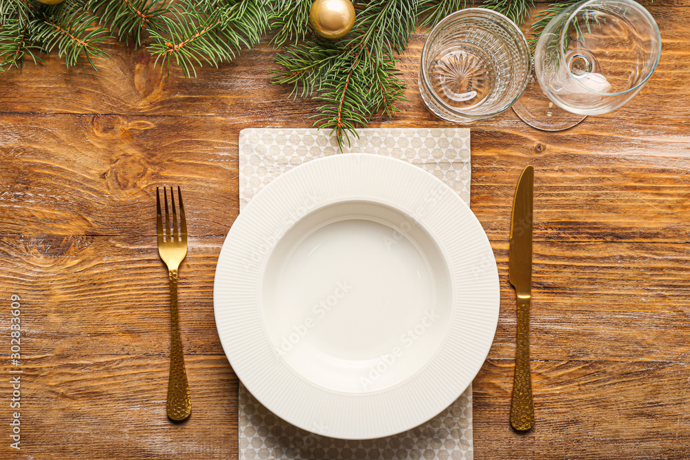 Beautiful table setting for Christmas dinner on wooden background Beautiful table setting for Christmas dinner on wooden background