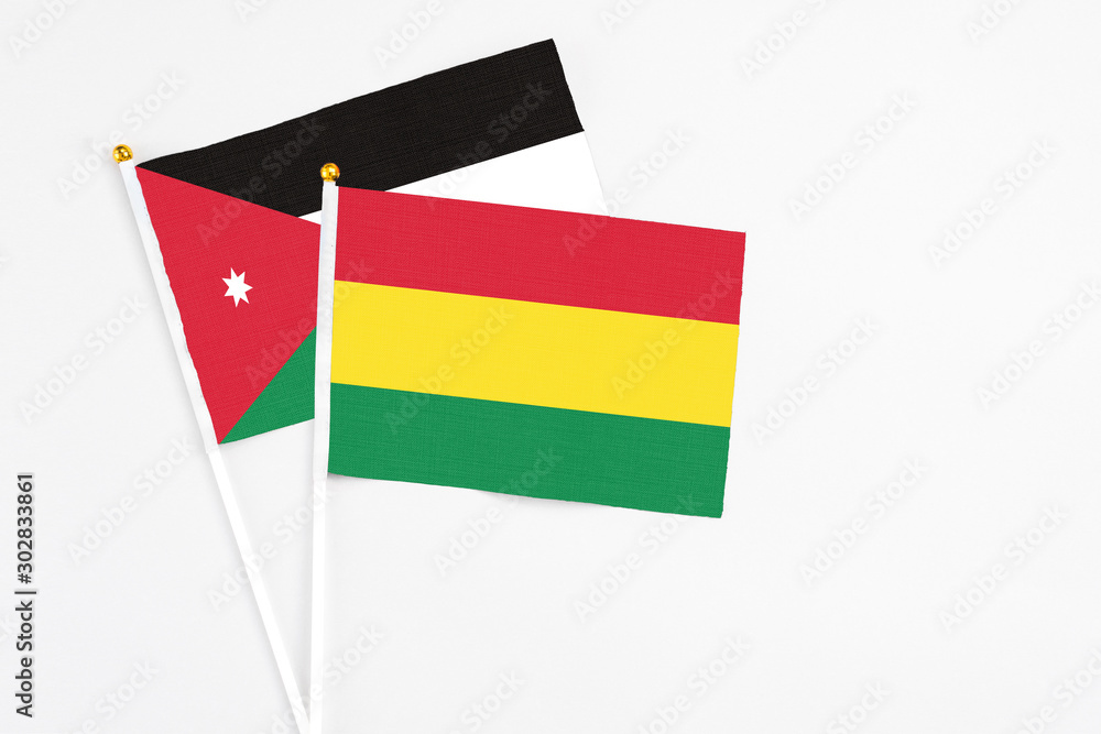 Bolivia and Jordan stick flags on white background. High quality fabric, miniature national flag. Peaceful global concept.White floor for copy space. Bolivia and Jordan stick flags on white background. High quality fabric, miniature national flag. Peaceful global concept.White floor for copy space.