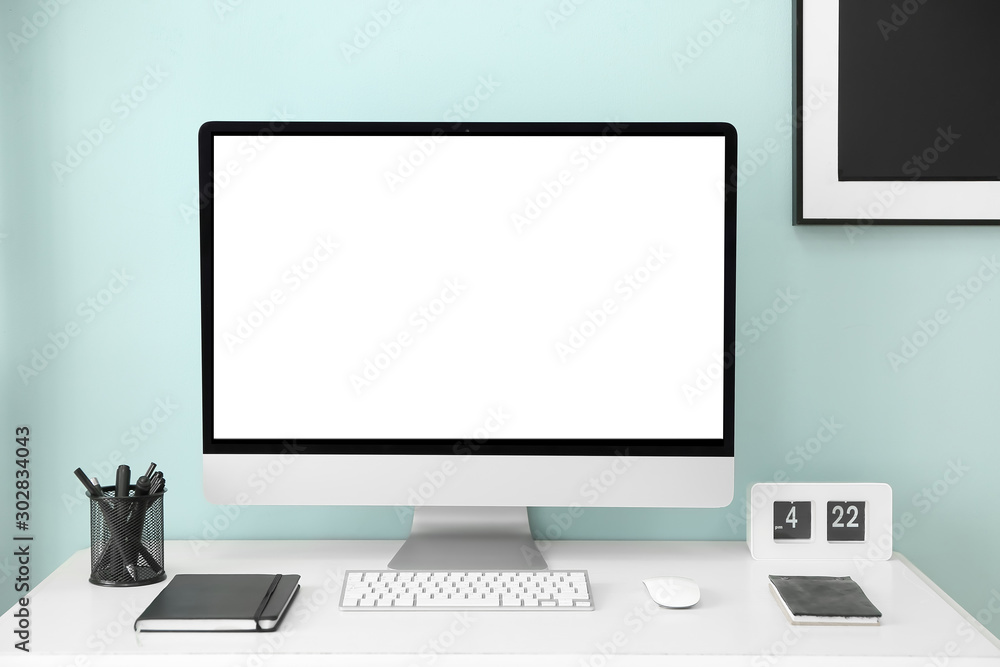 Fototapeta premium Comfortable workplace with modern computer near color wall