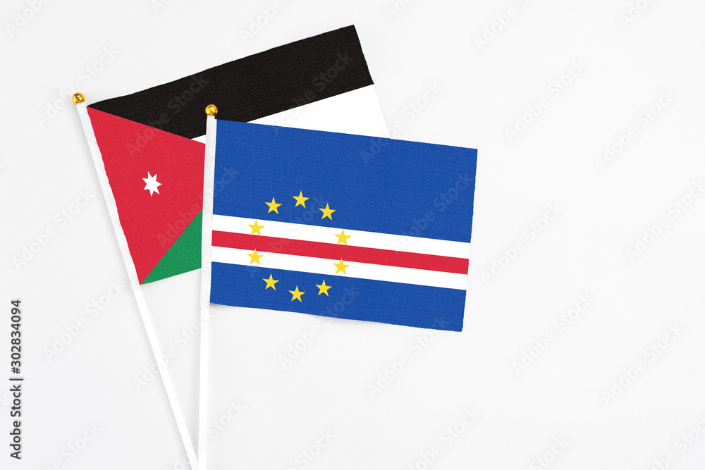 Cape Verde and Jordan stick flags on white background. High quality fabric, miniature national flag. Peaceful global concept.White floor for copy space. Cape Verde and Jordan stick flags on white background. High quality fabric, miniature national flag. Peaceful global concept.White floor for copy space.