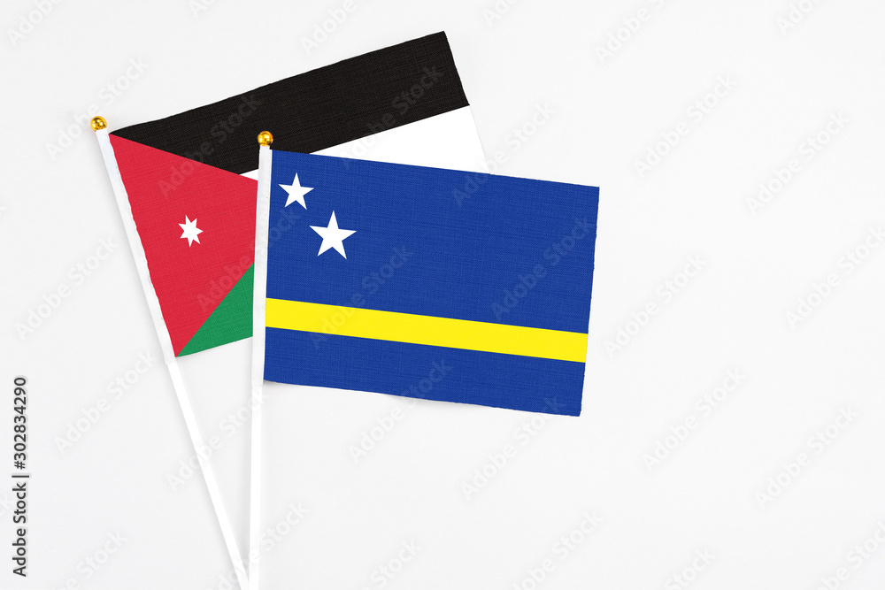 Curacao and Jordan stick flags on white background. High quality fabric, miniature national flag. Peaceful global concept.White floor for copy space. Curacao and Jordan stick flags on white background. High quality fabric, miniature national flag. Peaceful global concept.White floor for copy space.