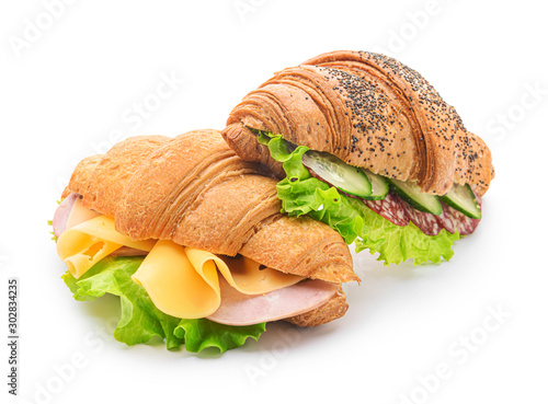 Tasty croissant sandwiches on white background