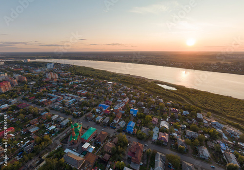 Aerial view of Tomsk city and Tom river, Red Cathedral Mosque, Russia. Summer, evening, sunset