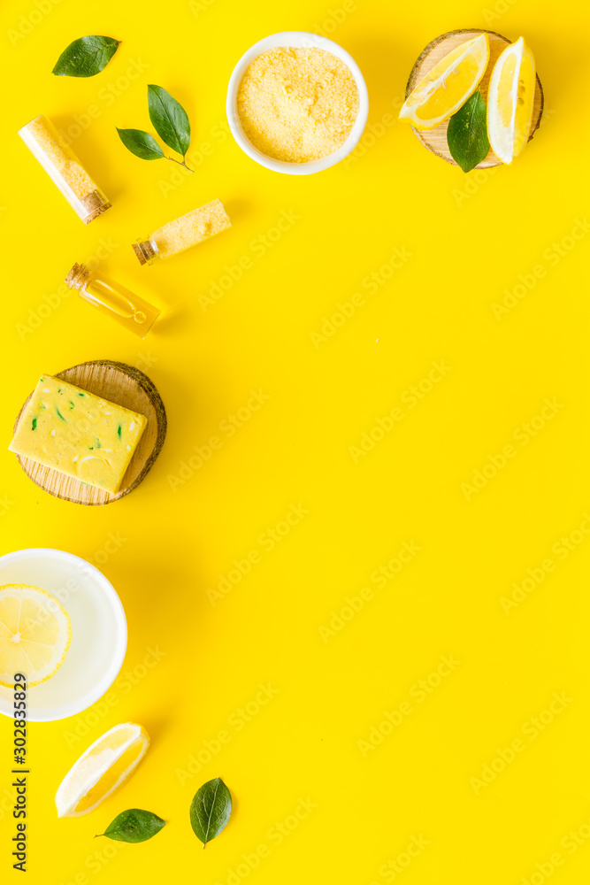 Fototapeta Lemon cosmetics. Cleansing tonic and handmade soap on yellow background top view frame copy space