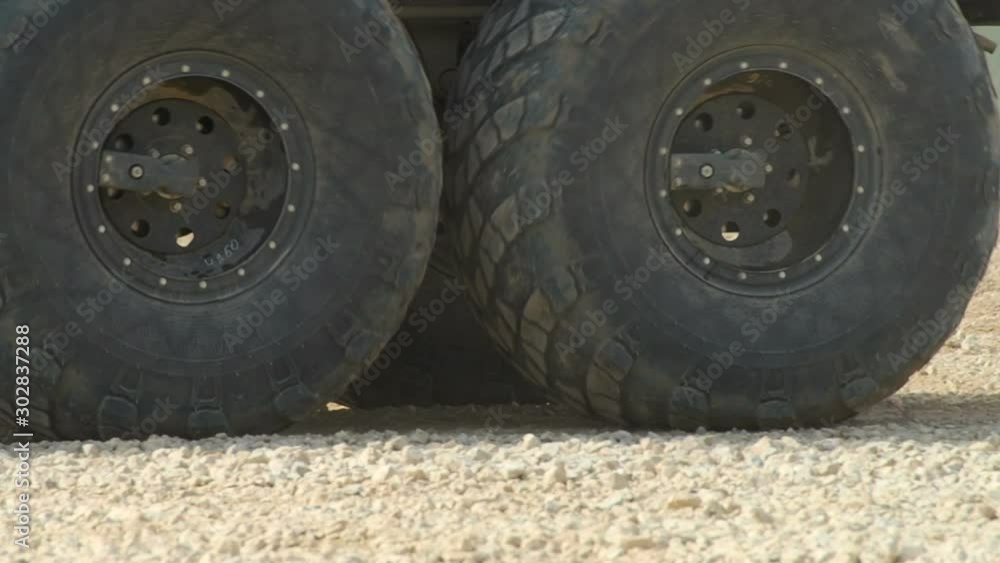 Heavy Military Truck Goes on Road Close-up Heavy Military Truck Goes on Road Close-up
