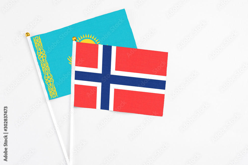 Bouvet Islands and Kazakhstan stick flags on white background. High quality fabric, miniature national flag. Peaceful global concept.White floor for copy space.