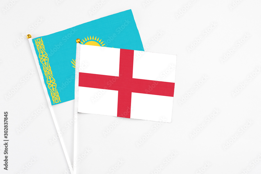 England and Kazakhstan stick flags on white background. High quality fabric, miniature national flag. Peaceful global concept.White floor for copy space.