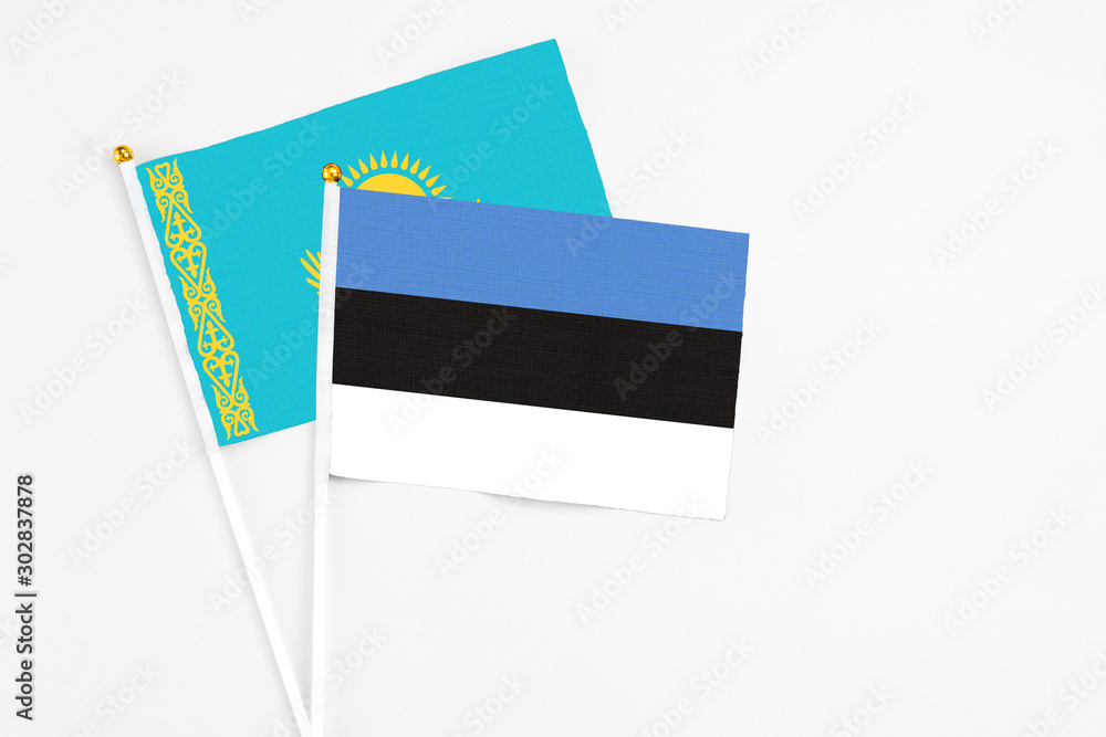 Estonia and Kazakhstan stick flags on white background. High quality fabric, miniature national flag. Peaceful global concept.White floor for copy space. Estonia and Kazakhstan stick flags on white background. High quality fabric, miniature national flag. Peaceful global concept.White floor for copy space.
