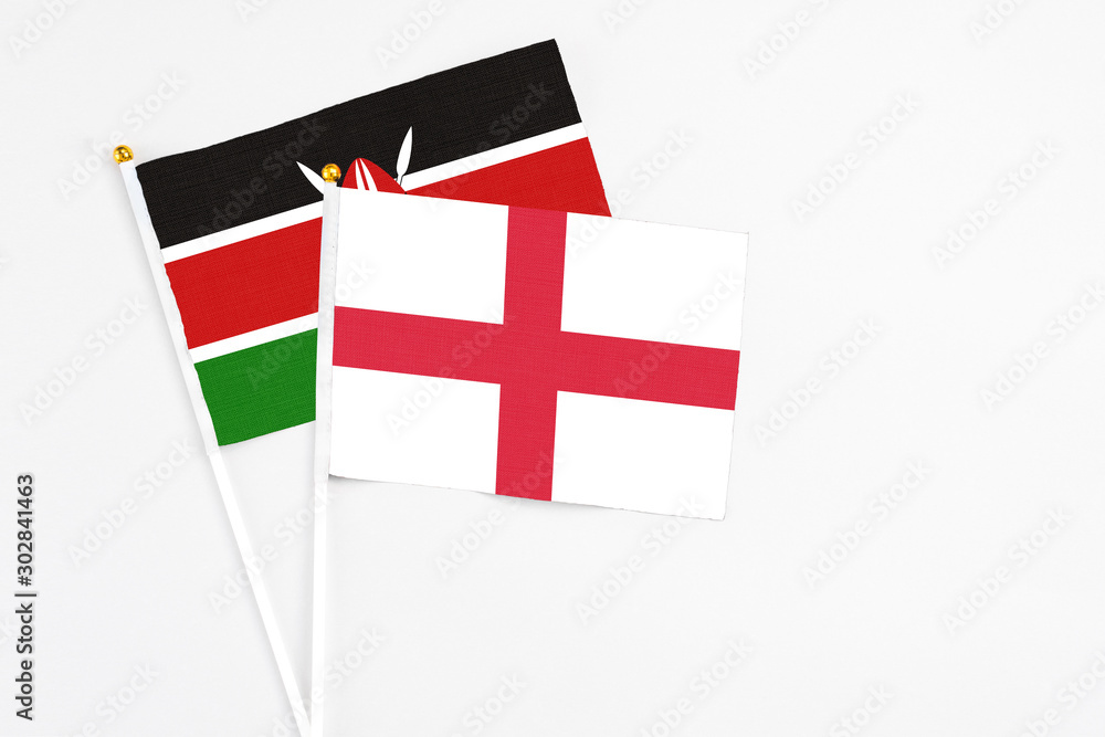 England and Kenya stick flags on white background. High quality fabric, miniature national flag. Peaceful global concept.White floor for copy space.