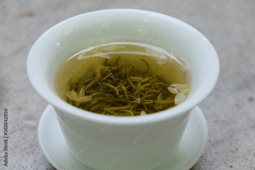 Close up tea water in traditional Chinese tea cup. Blur background Close up tea water in traditional Chinese tea cup. Blur background