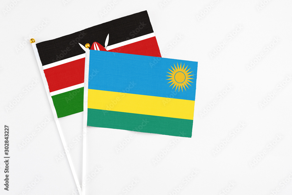 Rwanda and Kenya stick flags on white background. High quality fabric, miniature national flag. Peaceful global concept.White floor for copy space. Rwanda and Kenya stick flags on white background. High quality fabric, miniature national flag. Peaceful global concept.White floor for copy space.