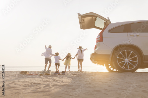 Father, mother, son and daughter, relaxing on the beach.