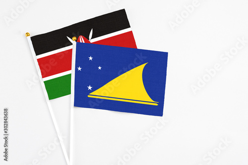 Free Download Tokelau and Kenya stick flags on white background. High quality fabric, miniature national flag. Peaceful global concept.White floor for copy space. - GFXLoad