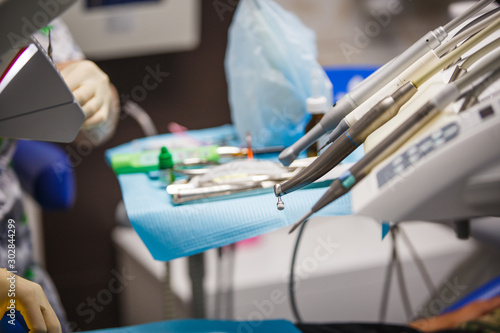 Working tools of the dentist. A cast of the jaw, Bor machine, work space and treatment of the patient in the blur