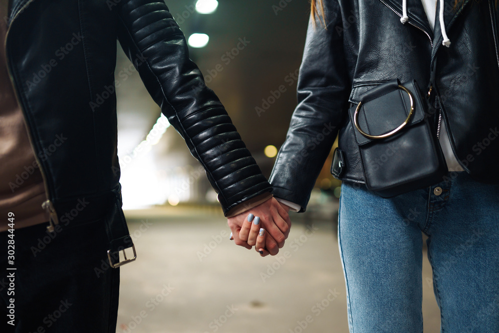 Close- up of a couple in love holding hand while  going through a dark tunnel. Hands and hearts together. Love, romantic, passion, tenderness  concept. - obrazy, fototapety, plakaty 