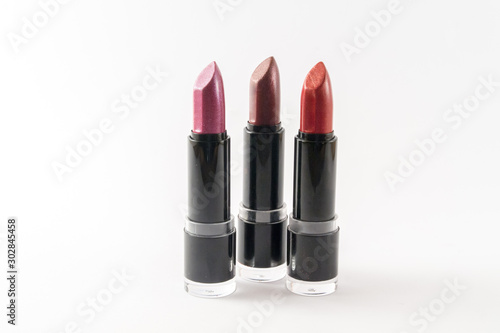 Three tones of lipstick isolated on white background.