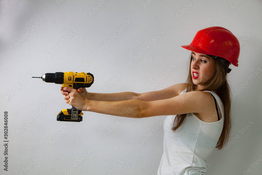 Woman using power driil for work at home Woman using power driil for work at home