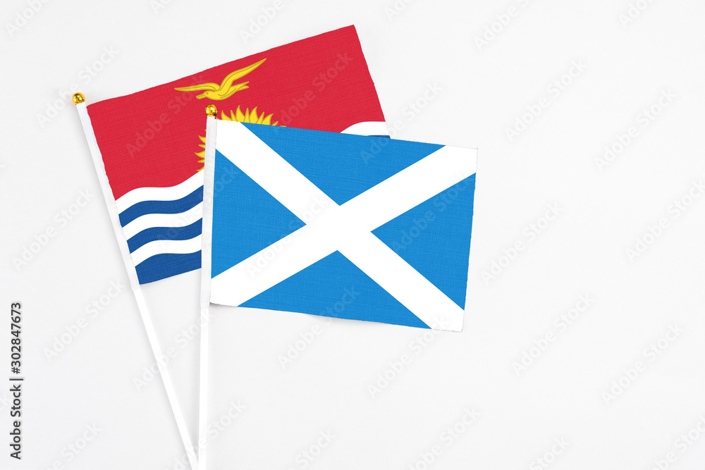 Scotland and Kiribati stick flags on white background. High quality fabric, miniature national flag. Peaceful global concept.White floor for copy space. Scotland and Kiribati stick flags on white background. High quality fabric, miniature national flag. Peaceful global concept.White floor for copy space.