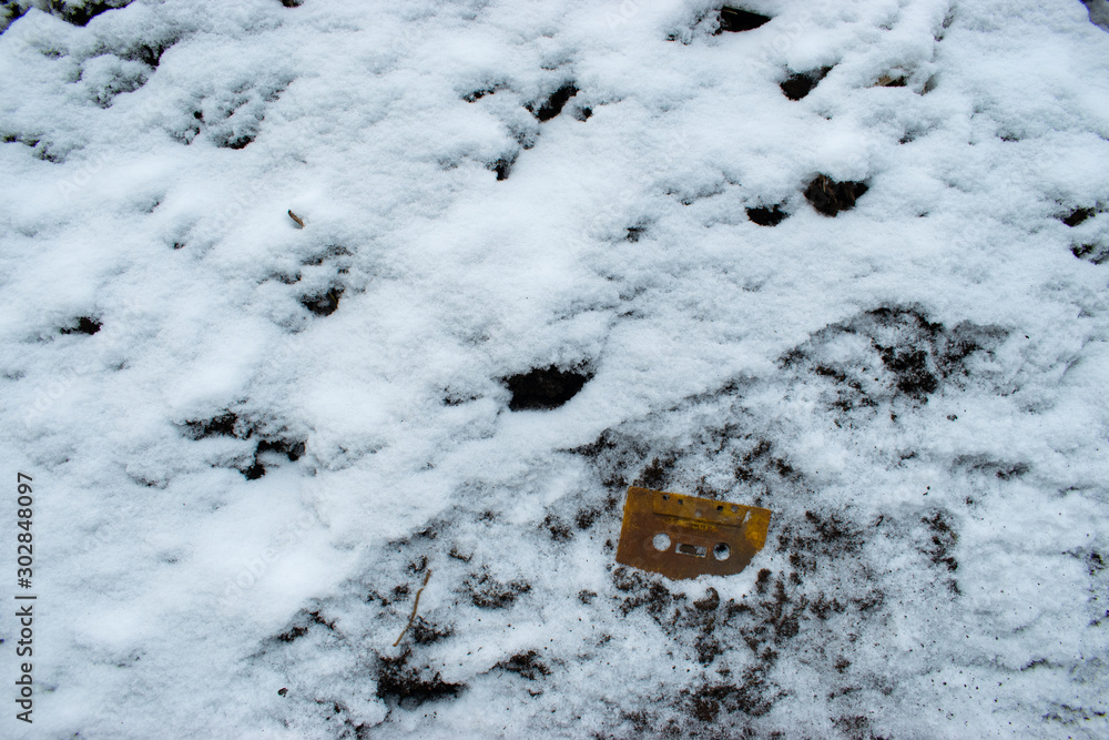 Frozen cassette tape in snow