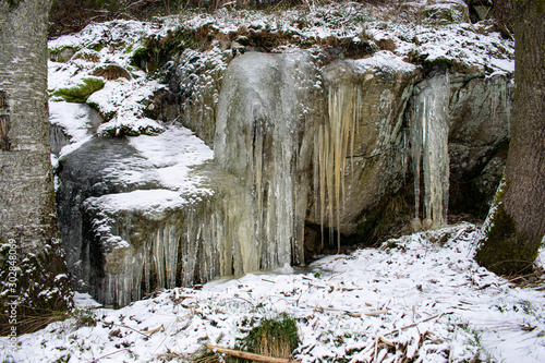 Frozen waterfall in forest