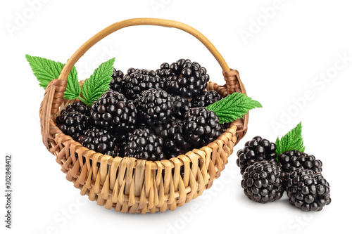 blackberry with leaf in a wicker basket isolated on a white background closeup