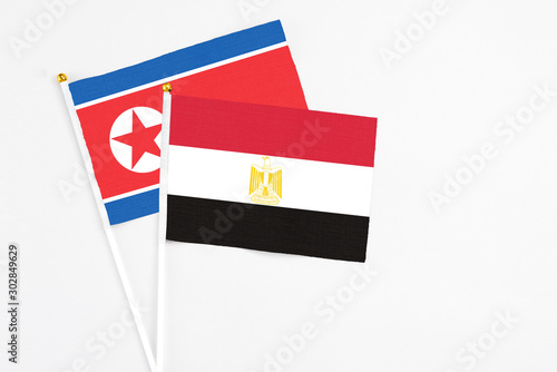 Free Download Egypt and North Korea stick flags on white background. High quality fabric, miniature national flag. Peaceful global concept.White floor for copy space. - GFXLoad