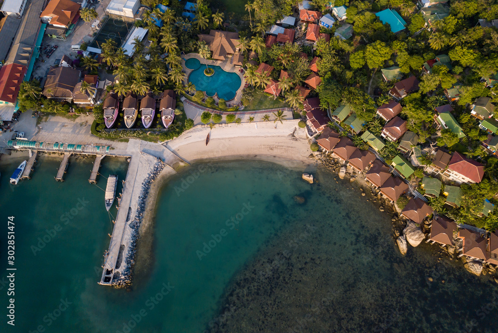 Aerial: Above  beachfront resort with sea view on beautiful tropical island koh Phangan, Haad Rin area 