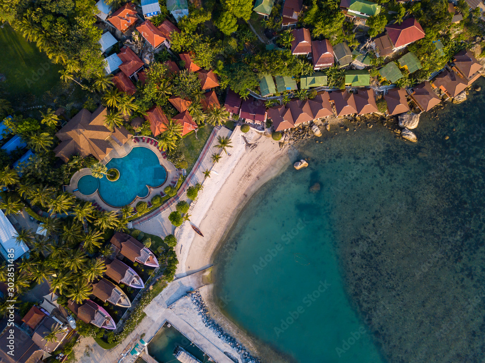 Aerial: Above  beachfront resort with sea view on beautiful tropical island koh Phangan, Haad Rin area  - obrazy, fototapety, plakaty 