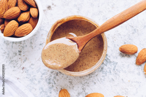 Almond nut butter in glass jar photo