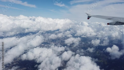 Wing of an airplane flying over the clouds
